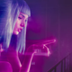 Ryan Gosling's K looks up at a large, neon holographic projection of a naked woman.